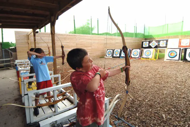 A kid shooting with an Archery Finger Tab.