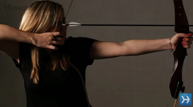 woman holding recurve bow on target